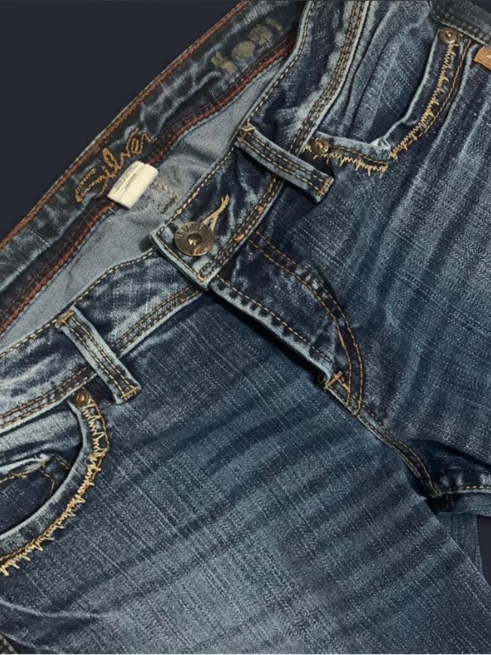 Low rise Silver Jeans dark indigo denim with brown stitching